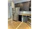 Stylish kitchen with stainless steel refrigerator and black cabinets at 11566 Balintore Dr, Riverview, FL 33579