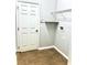 Laundry room with tile floor, shelving and a full sized door at 11566 Balintore Dr, Riverview, FL 33579
