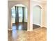 Bright living room with hardwood floors, two large windows, and decorative gray curtains at 11566 Balintore Dr, Riverview, FL 33579