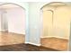 Bright, open living area featuring tile floors, arched doorways and neutral paint at 11566 Balintore Dr, Riverview, FL 33579