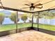 A cozy screened-in porch featuring brick pavers, a ceiling fan and lights at 11566 Balintore Dr, Riverview, FL 33579