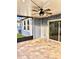 Beautiful screened porch with brick flooring, ceiling fan, and string lights at 11566 Balintore Dr, Riverview, FL 33579