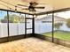 Spacious screened porch featuring brick pavers, a ceiling fan, and outdoor string lights at 11566 Balintore Dr, Riverview, FL 33579