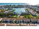 Aerial view highlighting the property's desirable location with a waterfront, community pool, and nearby amenities at 12308 Sun Vista W Ct # 45, Treasure Island, FL 33706