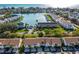 Stunning aerial view of waterfront townhomes with a community pool and Gulf views in the distance at 12308 Sun Vista W Ct # 45, Treasure Island, FL 33706