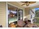 A cozy screened-in balcony with seating and a ceiling fan at 12308 Sun Vista W Ct # 45, Treasure Island, FL 33706