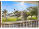 Balcony view of a road lined with green trees and grass on a sunny day at 12308 Sun Vista W Ct # 45, Treasure Island, FL 33706