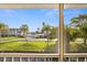 Balcony with view of a road lined with palm trees and well-manicured lawns at 12308 Sun Vista W Ct # 45, Treasure Island, FL 33706