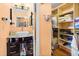 Bright bathroom with a vessel sink, dark wood cabinets and a walk in closet with built in shelving at 12308 Sun Vista W Ct # 45, Treasure Island, FL 33706
