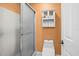 Simple bathroom featuring a toilet, shower with sliding doors, and a built in toiletry cabinet at 12308 Sun Vista W Ct # 45, Treasure Island, FL 33706