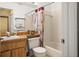 Bathroom with a wood vanity, toilet, and shower/tub combination with palm tree decor at 12308 Sun Vista W Ct # 45, Treasure Island, FL 33706
