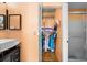 Bathroom featuring a sink, large closet, and walk in shower with peach colored walls and hardwood floors at 12308 Sun Vista W Ct # 45, Treasure Island, FL 33706