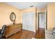 Comfortable bedroom with hardwood floors, a dresser, and closet space for convenient storage at 12308 Sun Vista W Ct # 45, Treasure Island, FL 33706