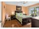 Cozy bedroom with warm wall color, sliding doors to a balcony, and ceiling fan at 12308 Sun Vista W Ct # 45, Treasure Island, FL 33706