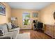 Cozy bedroom with hardwood floors, neutral paint, and a bright window showcasing the exterior at 12308 Sun Vista W Ct # 45, Treasure Island, FL 33706