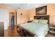 Comfortable bedroom with a dark wood bed frame, hardwood floors, and a closet in a peach-colored room at 12308 Sun Vista W Ct # 45, Treasure Island, FL 33706