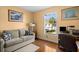 Serene bedroom with warm tones, hardwood floors, and a window view of the landscaped surroundings at 12308 Sun Vista W Ct # 45, Treasure Island, FL 33706