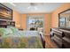 Inviting bedroom with private balcony, ceiling fan and warm toned walls at 12308 Sun Vista W Ct # 45, Treasure Island, FL 33706