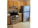 A cozy kitchen featuring wooden cabinets, stainless steel appliances, and ample counter space at 12308 Sun Vista W Ct # 45, Treasure Island, FL 33706