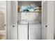 Laundry closet with two white appliances and wire rack shelving at 12308 Sun Vista W Ct # 45, Treasure Island, FL 33706