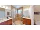 Bathroom featuring a glass enclosed shower, double sink vanity, and neutral wall color at 15644 Aurora Lake Cir, Wimauma, FL 33598