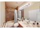 A bathroom with neutral color walls, a single sink vanity, and a shower with bathtub combination at 15644 Aurora Lake Cir, Wimauma, FL 33598