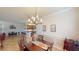 Elegant dining area featuring a stylish chandelier, wood table and decor at 15644 Aurora Lake Cir, Wimauma, FL 33598