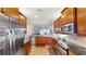 Well-equipped kitchen featuring stainless steel appliances and sleek granite countertops for modern cooking convenience at 15644 Aurora Lake Cir, Wimauma, FL 33598