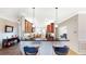 Open-concept kitchen with stainless steel appliances and a breakfast bar at 15644 Aurora Lake Cir, Wimauma, FL 33598