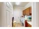Functional laundry room with modern appliances, cabinets, and ample counter space at 15644 Aurora Lake Cir, Wimauma, FL 33598