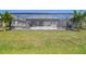 Spacious backyard with grass and screened in pool and patio at 17441 Savory Mist Cir, Bradenton, FL 34211