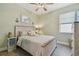 Cozy bedroom with a full bed, soft green walls, neutral bedding, and plenty of natural light at 17441 Savory Mist Cir, Bradenton, FL 34211