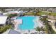 Aerial view of a resort-style community pool featuring lounge chairs and lush landscaping at 17441 Savory Mist Cir, Bradenton, FL 34211