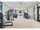 Spacious gym features modern machines and abundant natural light, creating an energizing workout environment at 17441 Savory Mist Cir, Bradenton, FL 34211