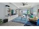 Living room with built-in shelving, large TV, and sliding glass doors to backyard with water view at 17441 Savory Mist Cir, Bradenton, FL 34211