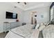 Bright main bedroom features a TV, dresser, and neutral tones create a serene retreat at 17441 Savory Mist Cir, Bradenton, FL 34211