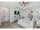 Comfortable main bedroom includes ensuite bath, walk-in closet, TV and neutral tones create a serene retreat at 17441 Savory Mist Cir, Bradenton, FL 34211