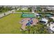 A large playground area with swings, climbing structure, basketball and tennis courts amidst a backdrop of lush landscaping at 17441 Savory Mist Cir, Bradenton, FL 34211