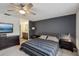 Comfortable bedroom featuring a dark accent wall, and a view into the bathroom at 1814 Cypress Trace Dr, Safety Harbor, FL 34695