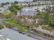 Aerial view of a gated community with a lake, pool, and lush green landscaping at 209 Seahorse Se Dr # D, St Petersburg, FL 33705