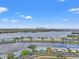 Scenic aerial view features a lake, colorful condos, and a city skyline at 209 Seahorse Se Dr # D, St Petersburg, FL 33705