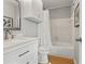 Bathroom featuring vanity with hard surface counter top and a tub/shower combo at 209 Seahorse Se Dr # D, St Petersburg, FL 33705
