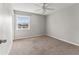 Bright bedroom featuring neutral carpet, ceiling fan and a window at 209 Seahorse Se Dr # D, St Petersburg, FL 33705