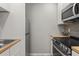 Modern kitchen featuring stainless steel appliances, gray backsplash, and butcher block counters at 209 Seahorse Se Dr # D, St Petersburg, FL 33705