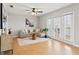 Neutral living room featuring hardwood floors, a sofa, large windows, and modern decor at 209 Seahorse Se Dr # D, St Petersburg, FL 33705