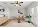 Bright living room with hardwood floors, a sectional sofa, and natural light at 209 Seahorse Se Dr # D, St Petersburg, FL 33705