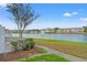 A beautiful water view featuring a large lake, fountain, and colorful condominiums at 209 Seahorse Se Dr # D, St Petersburg, FL 33705