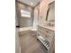 Bright bathroom features marble tile, a shower-tub combo, and a modern vanity at 2602 Surrey Dr, Palm Harbor, FL 34684