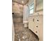 Bright bathroom features patterned tile floors, a tile shower, and a modern vanity at 2602 Surrey Dr, Palm Harbor, FL 34684