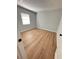 Empty room with wood-look floors and a window at 2602 Surrey Dr, Palm Harbor, FL 34684